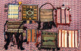 A GROUP OF EIGHT SADDLE BAGS TO INCLUDE A TURKMEN EXAMPLE HEIGHT 35CM. LENGTH 45CM.