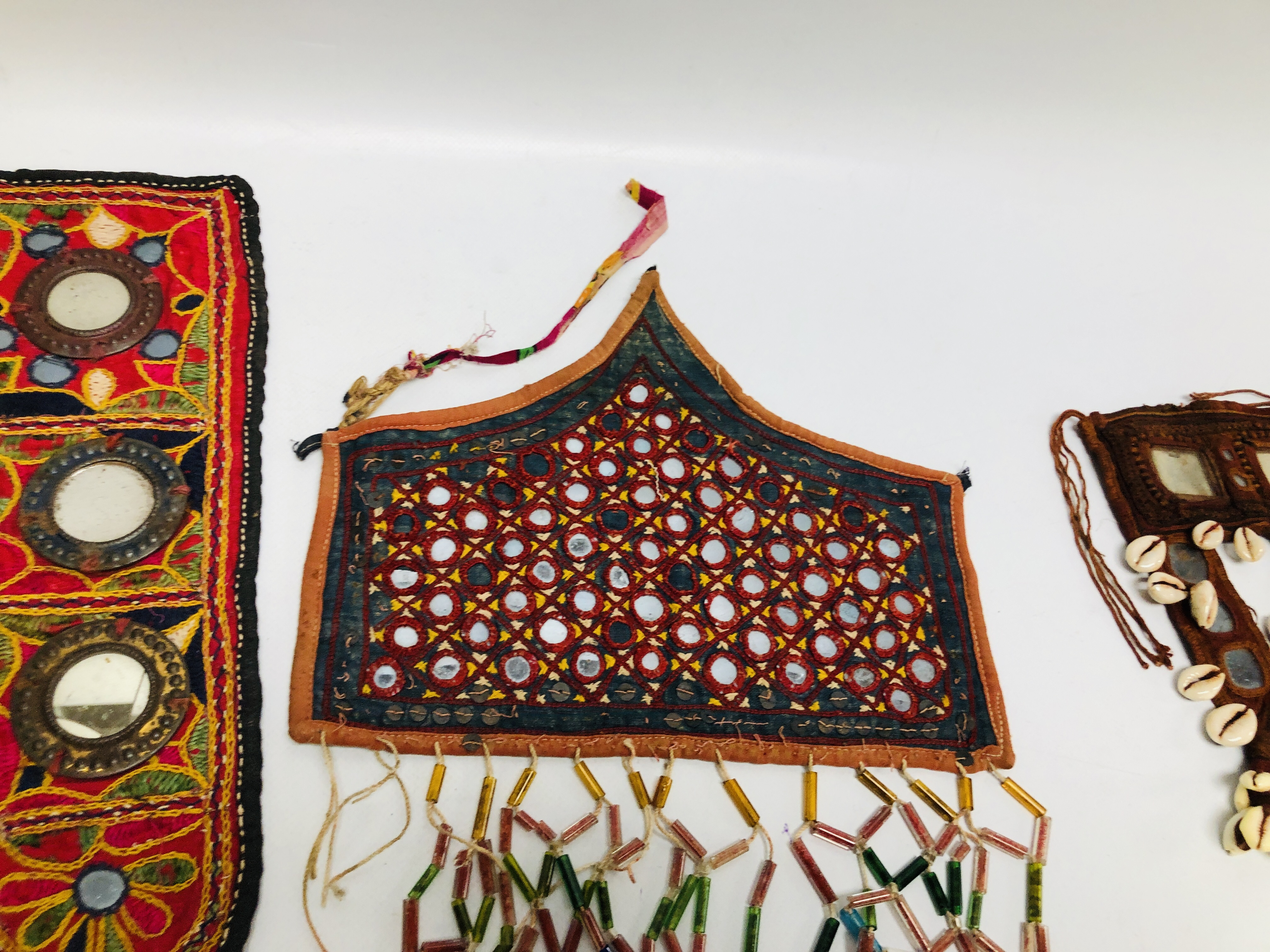 A COLLECTION OF EASTERN AND ASIAN TRIBAL ART FACE MASKS TO INCLUDE SHISHA AND NEEDLEWORK EXAMPLES. - Image 6 of 8