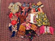 A GROUP OF ETHNIC AND TRIBAL GARMENTS TO INCLUDE "CHOLI" ELABORATELY EMBROIDERED, SHISHA EXAMPLES.