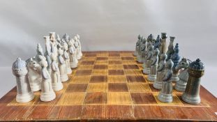 AN IMPRESSIVE LLADRO MEDIEVAL CHESS SET ALONG WITH A FITTED PINE CHESS BOARD BOX - W 76CM. X D 71CM.