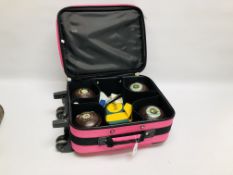 A SET OF 4 TAYLOR SIZE 1 LAWN BOWLS IN FITTED PINK TAYLOR TRAVEL CASE WITH ACCESSORIES