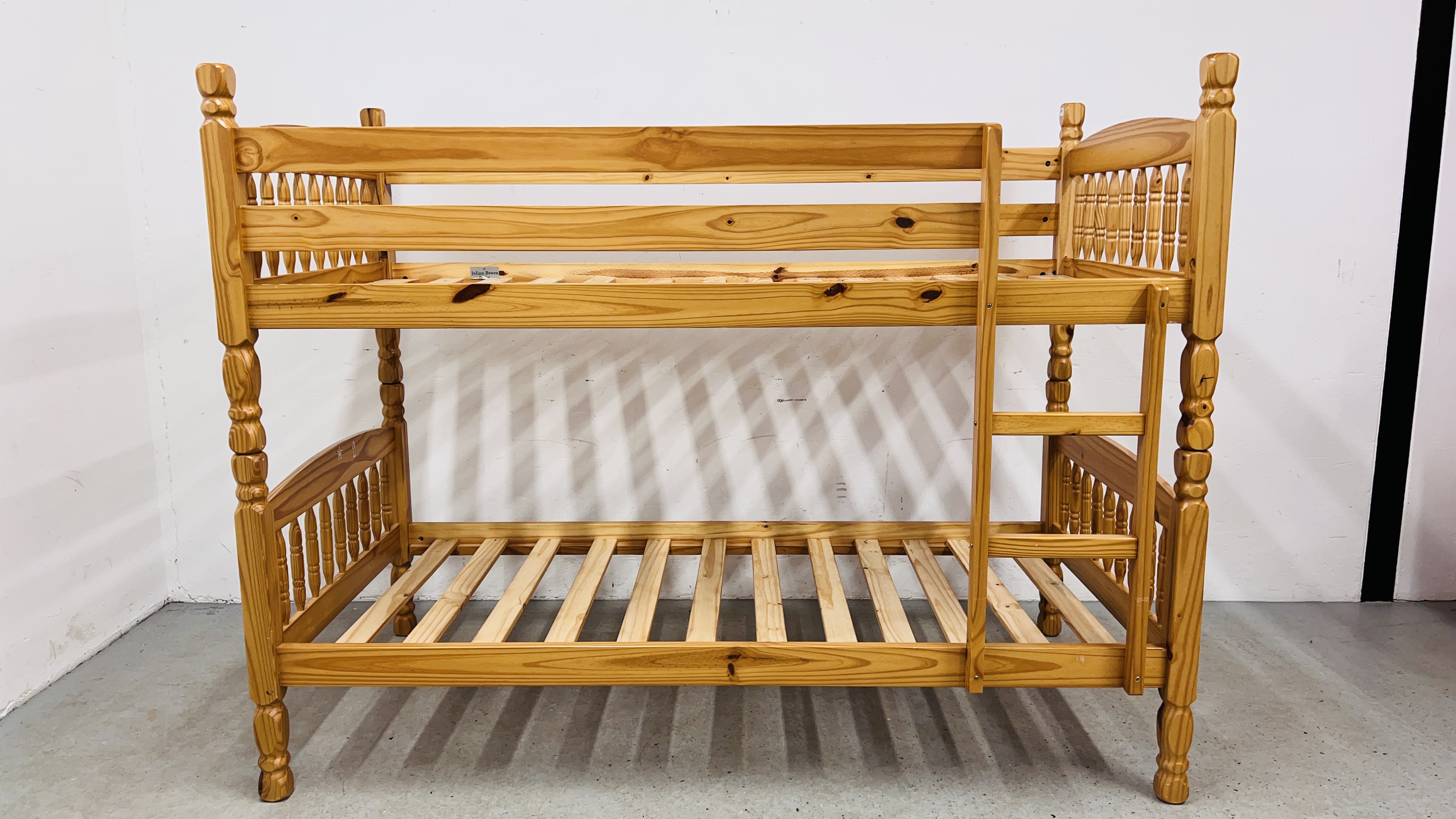 A PINE FRAME BUNK BED