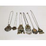 A GROUP OF 6 ASSORTED EASTERN STYLE WHITE METAL PENDANT NECKLACES TO INCLUDE STONE SET EXAMPLES.
