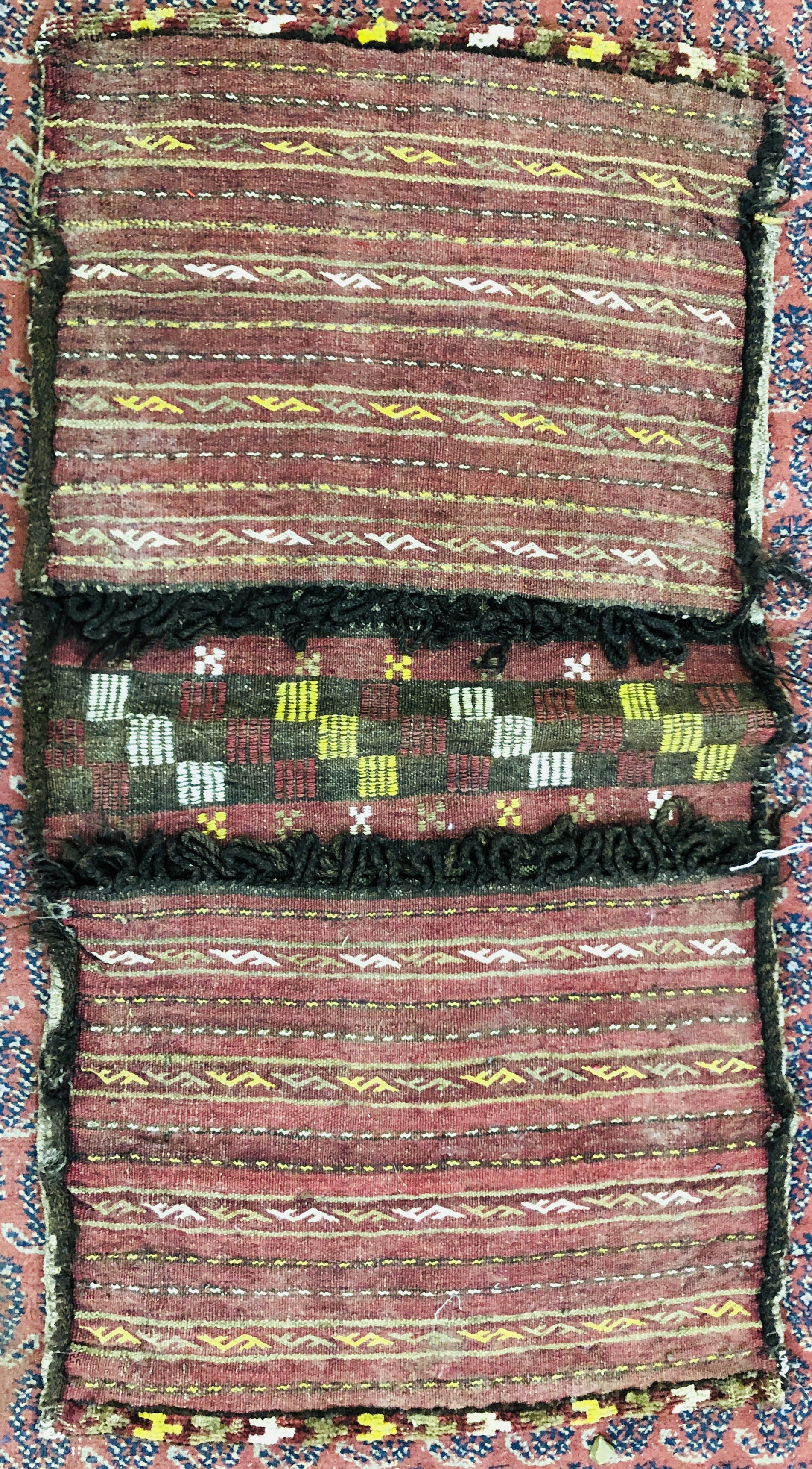 A DOUBLE SADDLE BAG WOVEN WITH COLUMNS INCLUDING STYLIZED "S" DESIGNS, PROBABLY BELOUCH WIDTH 111CM.