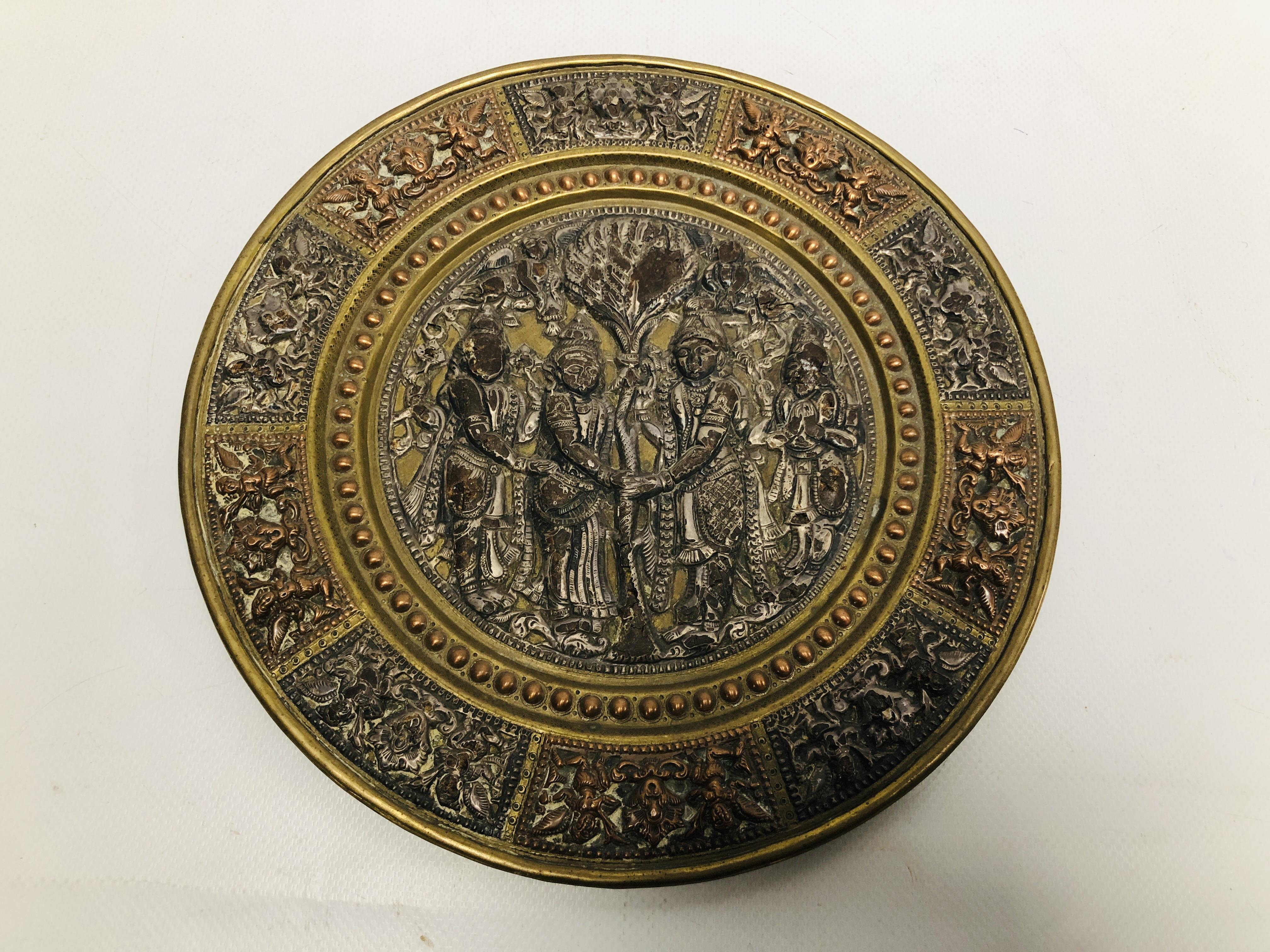 AN INDIAN BRASS AND COPPER MARRIAGE PLATE THE CENTRE WITH SILVERED FIGURES,