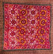 A SUZANI EMBROIDERED ON A PLUM FIELD, 180CM X 171CM.