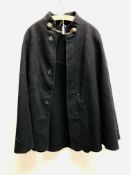 A VINTAGE BLACK FELT CAPE ON AN ORIGINAL WOODEN COAT HANGER TAILORS EDWARDS AND GITTINGS GILLINGHAM.