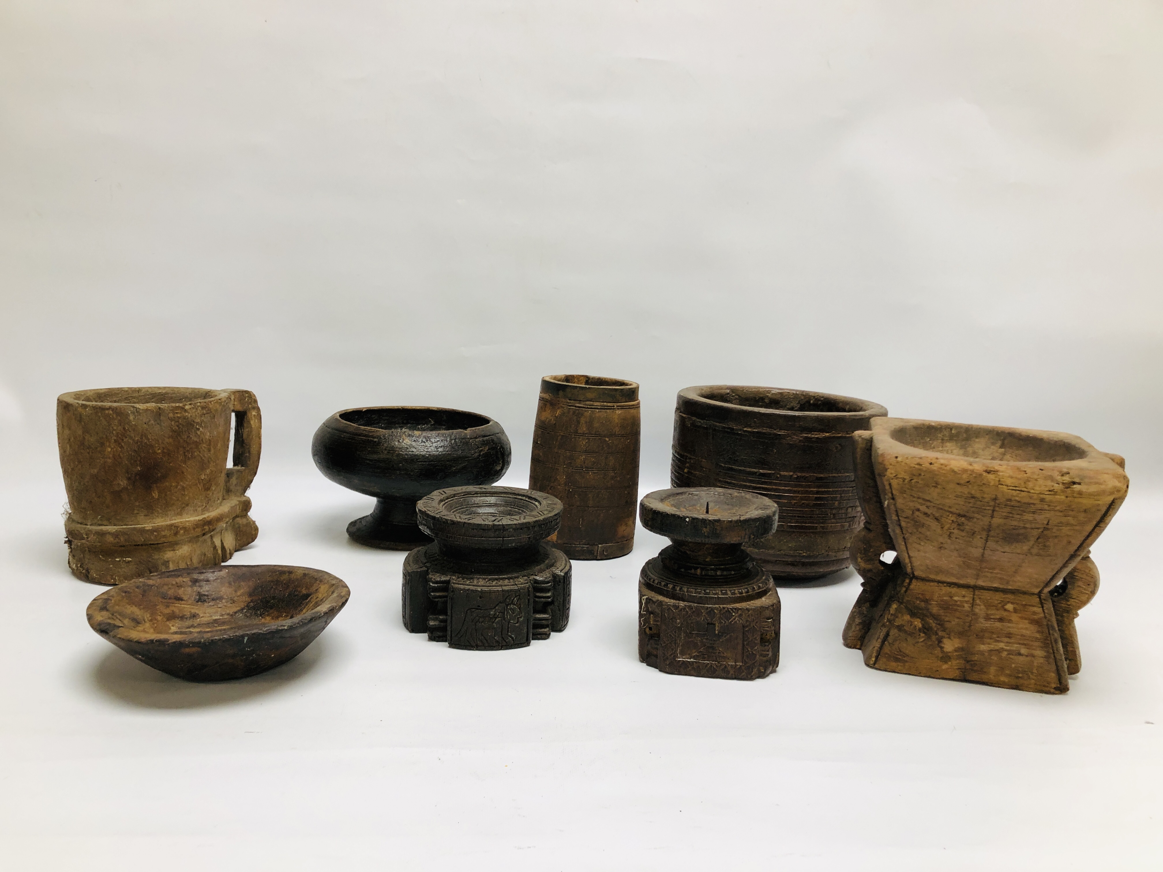 A GROUP OF MAINLY ETHNIC HARDWOOD CARVED ARTIFACTS COMPRISING OF VARIOUS VESSELS AND CANDLE HOLDERS