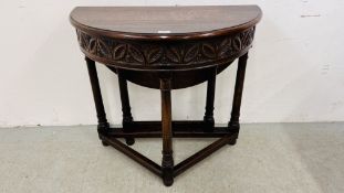 AN OAK DEMI LUNE GATELEG TABLE WITH CARVED FREEZE W 85CM.