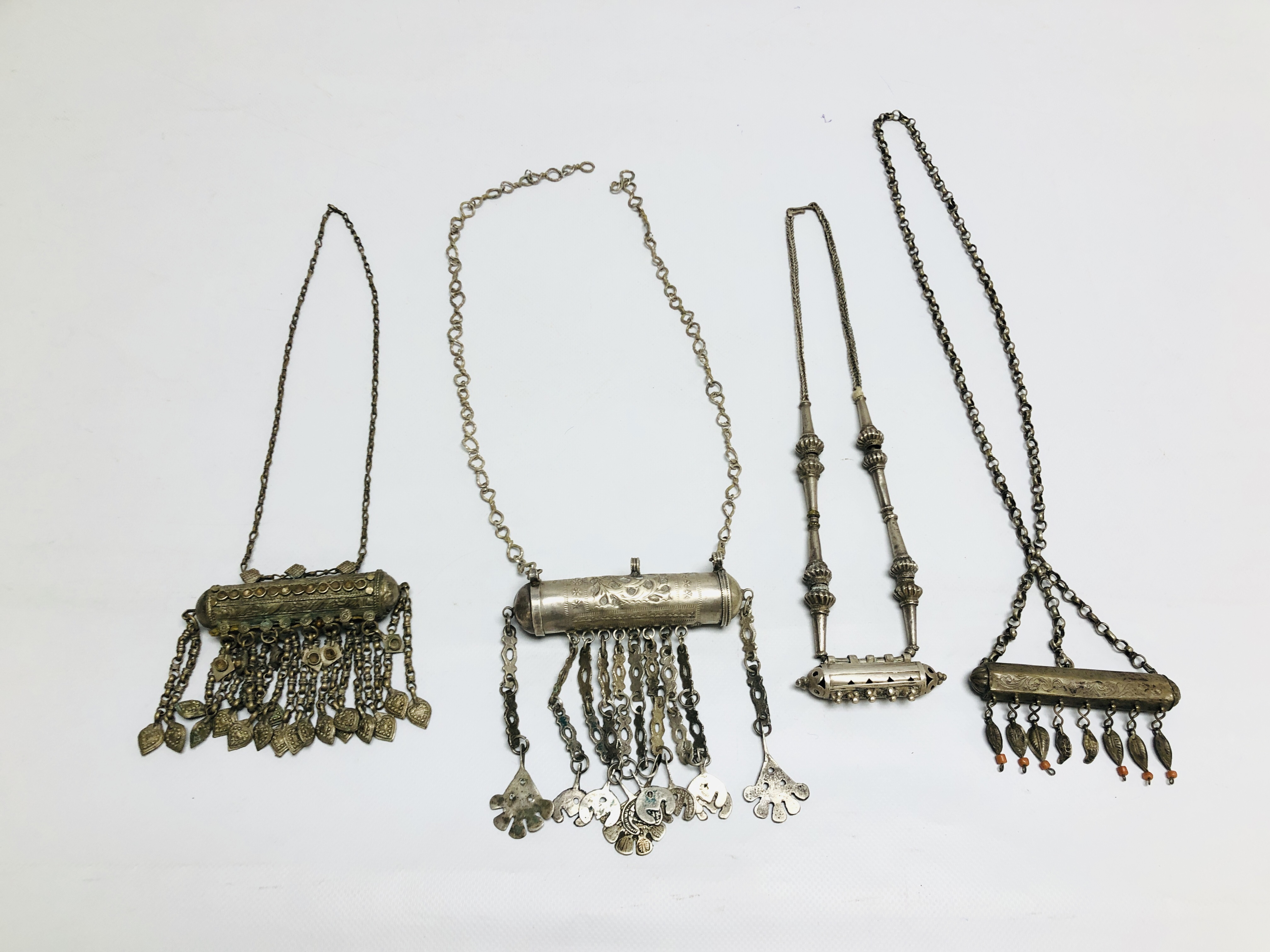 A GROUP OF 4 EASTERN STYLE WHITE METAL NECKLACES.