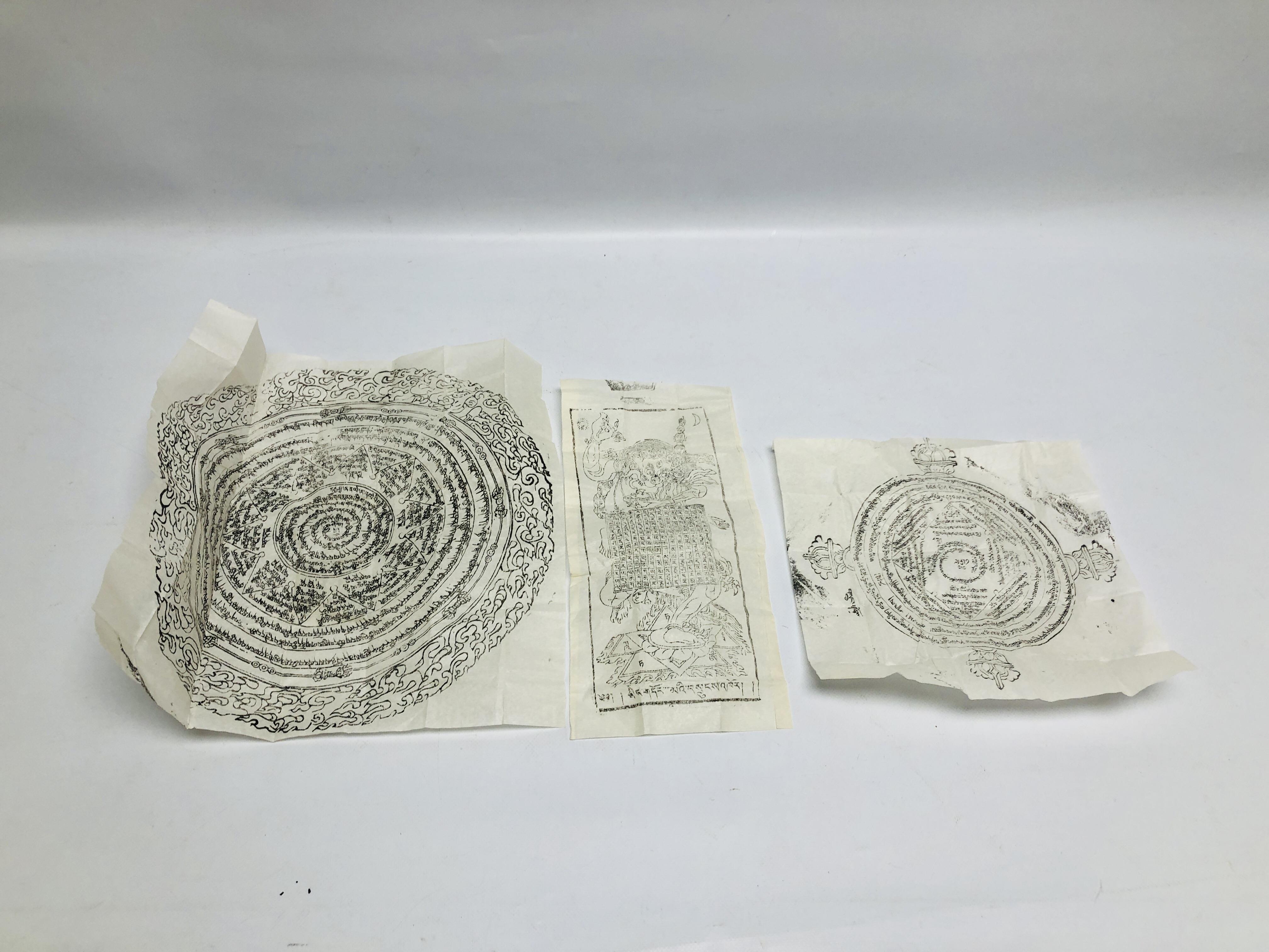 A GROUP OF THREE TIBETAN BUDDHIST INK DRAWINGS ON RICE PAPER, TWO OF INSCRIBED WHEEL DESIGN,