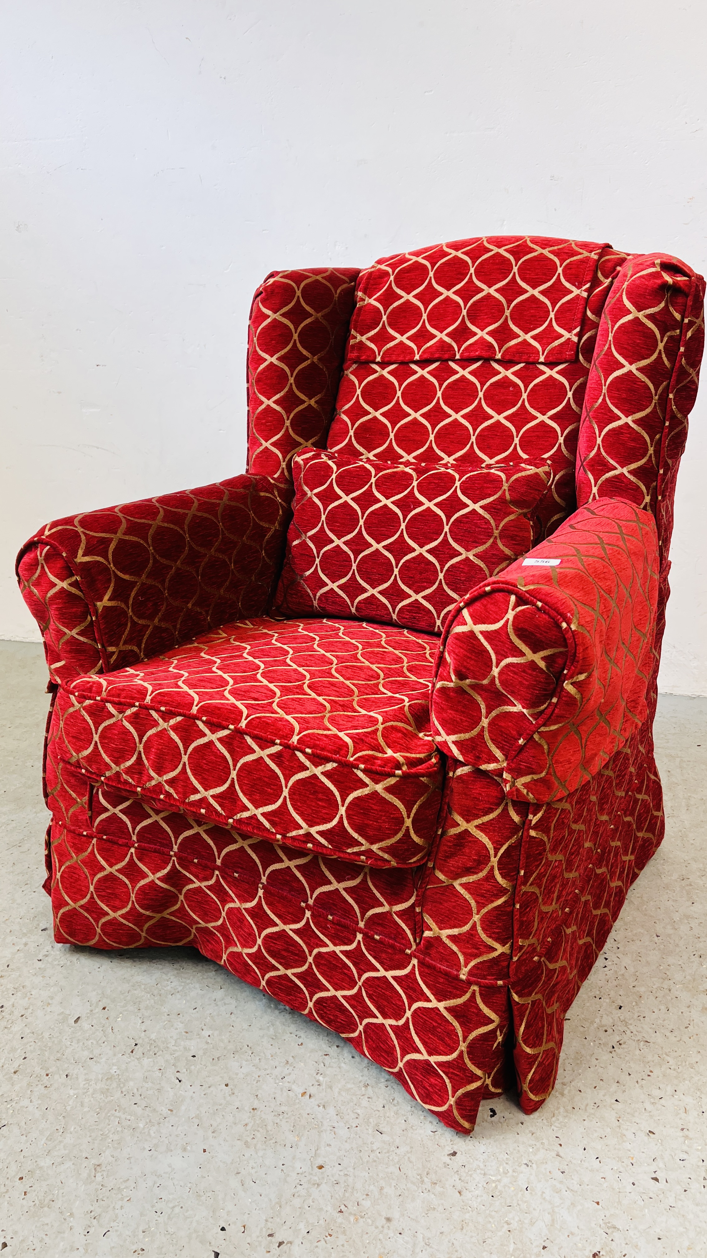 A MODERN WING BACK CHAIR UPHOLSTERED IN RED AND GOLD