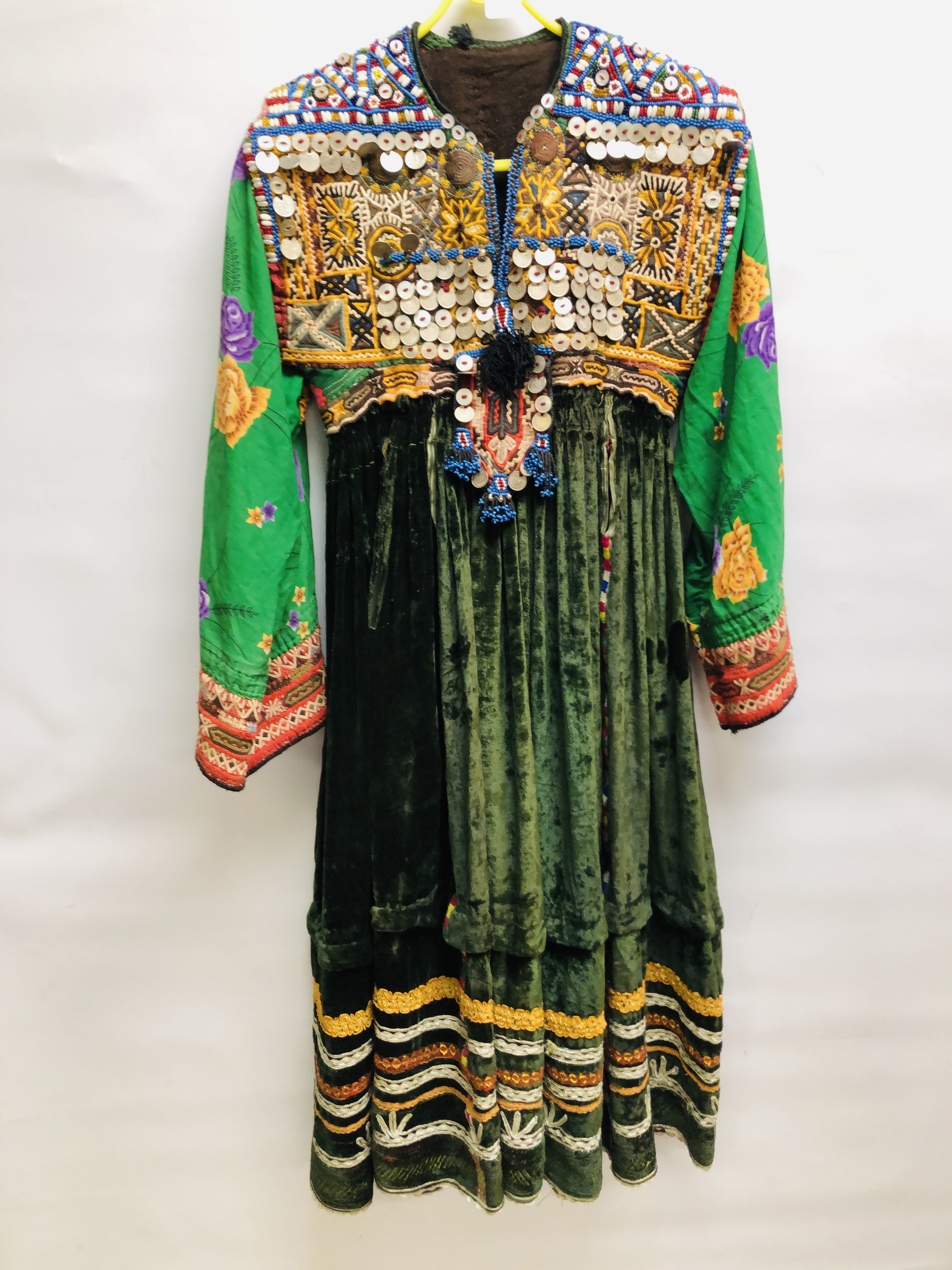 A VINTAGE AFGHAN KUCHI STYLE TRIBAL DRESS DECORATED WITH ELABORATE EMBROIDERY INTRICATE BEADWORK,