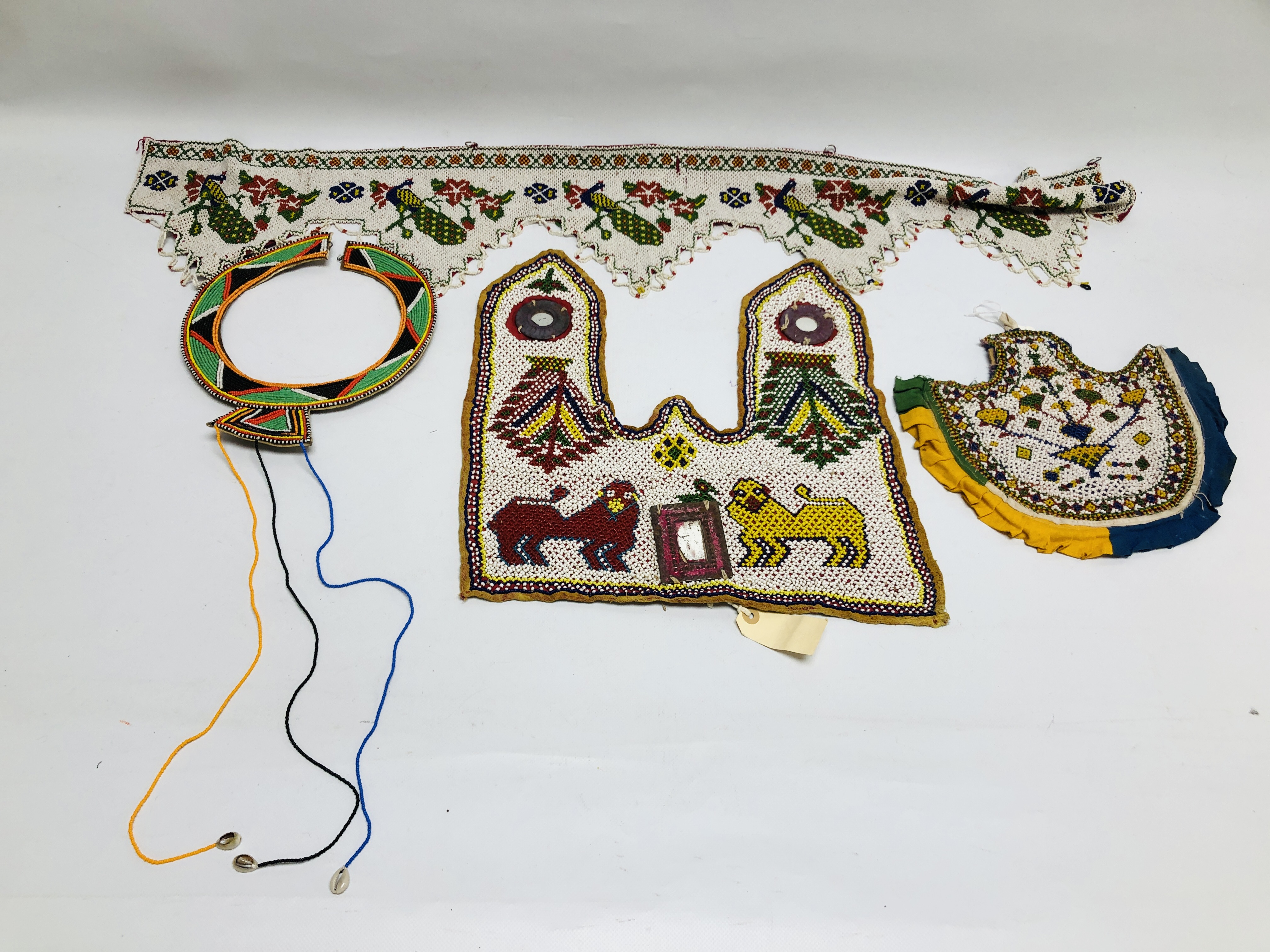 A COLLECTION OF INDIAN INSPIRED BEAD WORK EXAMPLES TO INCLUDE A TRIBAL NECK COLLAR.