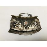 AN ELABORATE EASTERN TRIBAL STYLE PURSE, THE MAIN BODY LEATHER WITH APPLIED METAL WORK.