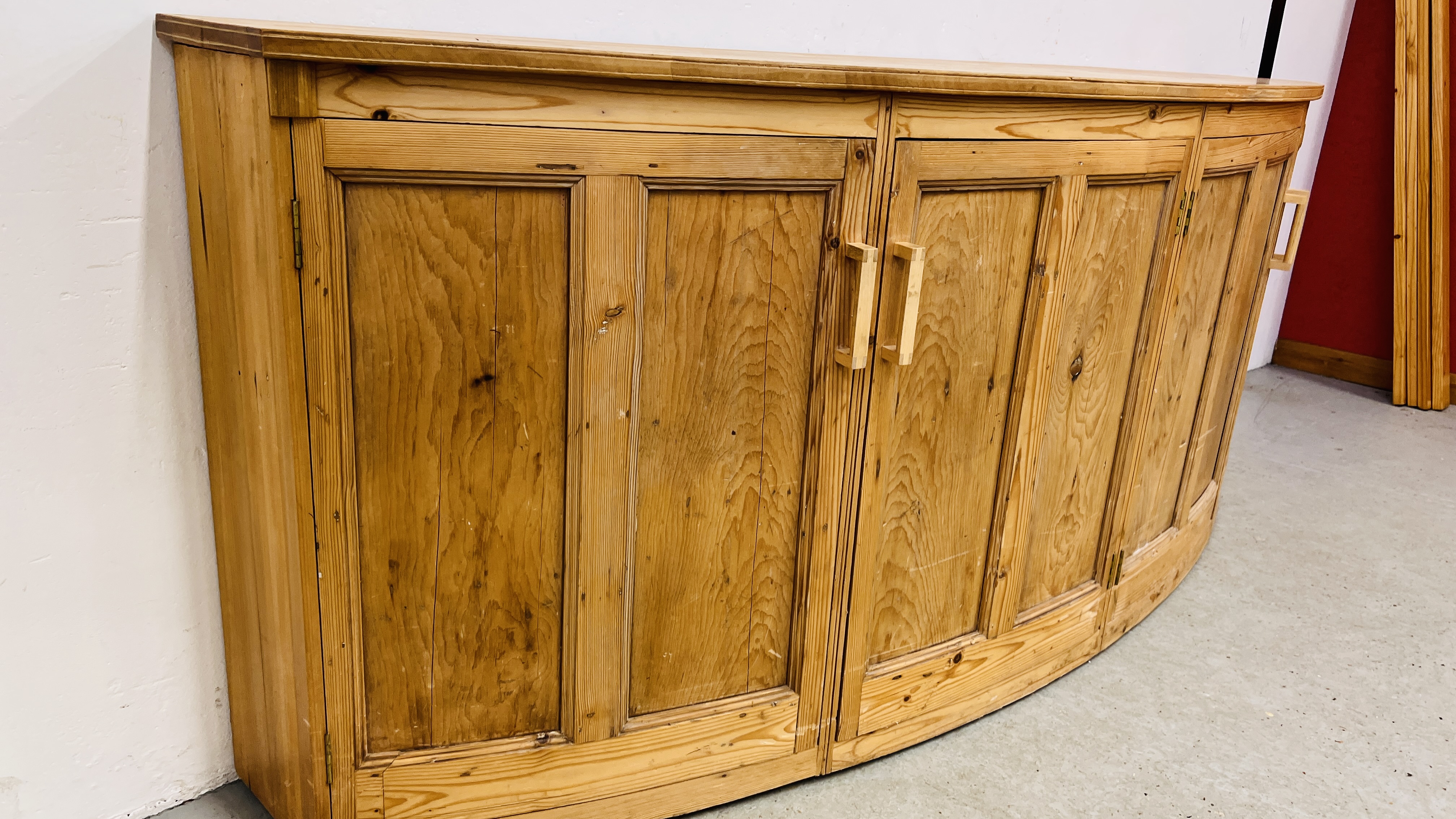 A LARGE SOLID PINE BOW FRONTED 4 DOOR SIDE CABINET W 246CM. X D 61CM. X H 96CM. - Image 9 of 11