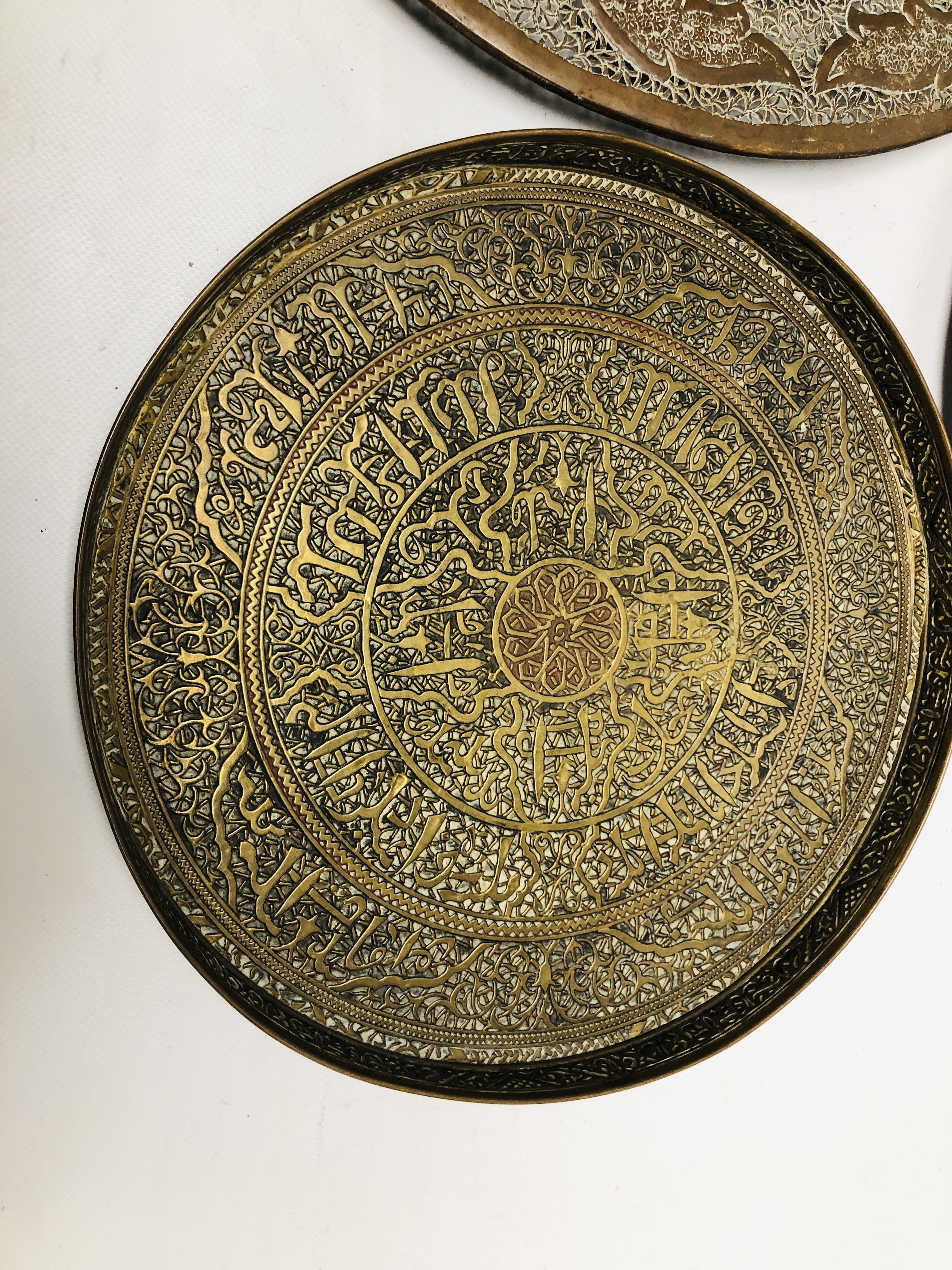 A GROUP OF MIDDLE EASTERN AND ASIAN METAL WARE COMPRISING OF TWO CHARGERS OF PIERCED DESIGN AND A - Image 2 of 8