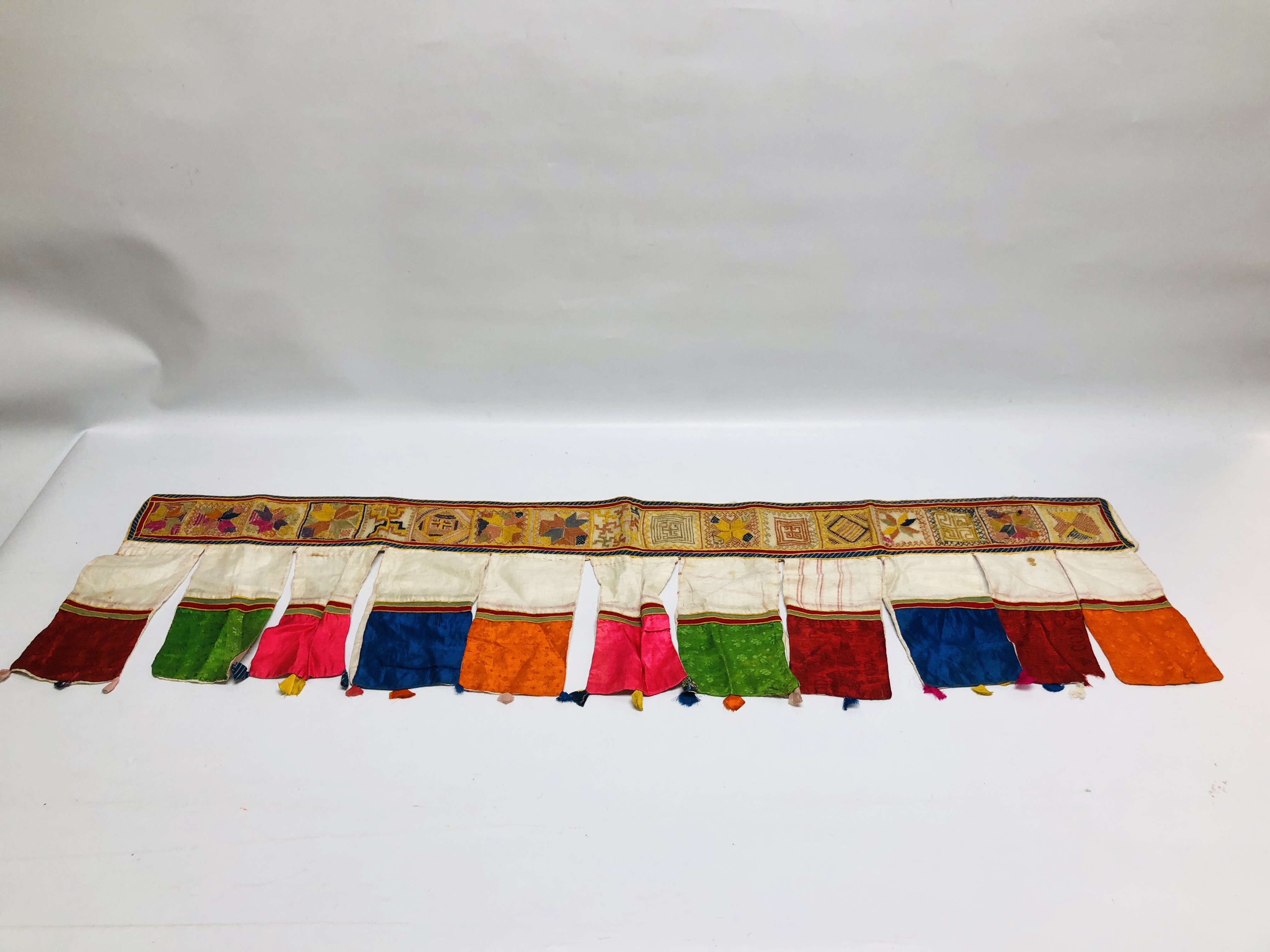 A HANDMADE ETHNIC TRIBAL SILK AND EMBROIDERED DOOR / WINDOW HANGING.