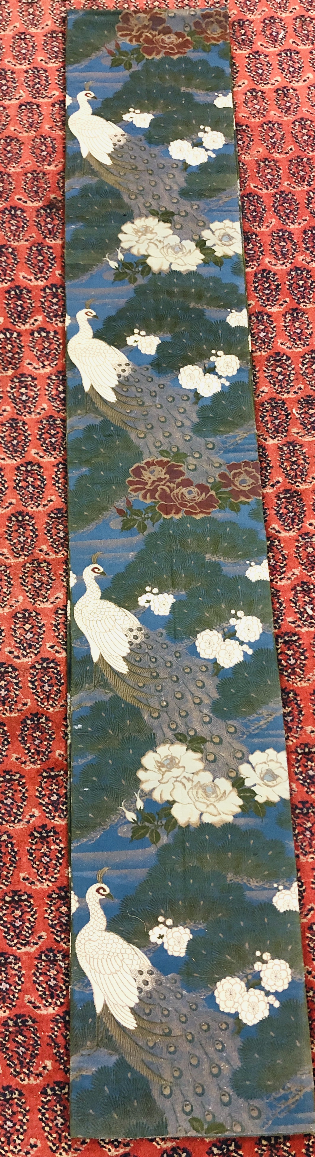A CHINESE SILK "OBI" ON A DARK BLUE FIELD DECORATED WITH PEACOCKS AND FLOWERS. - Image 2 of 4
