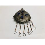 AN ELABORATE LARGE EASTERN TRIBAL STYLE PENDANT, HAMMERED DESIGN INSET WITH COLOURED GLASS.