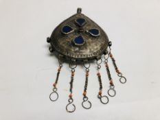 AN ELABORATE LARGE EASTERN TRIBAL STYLE PENDANT, HAMMERED DESIGN INSET WITH COLOURED GLASS.