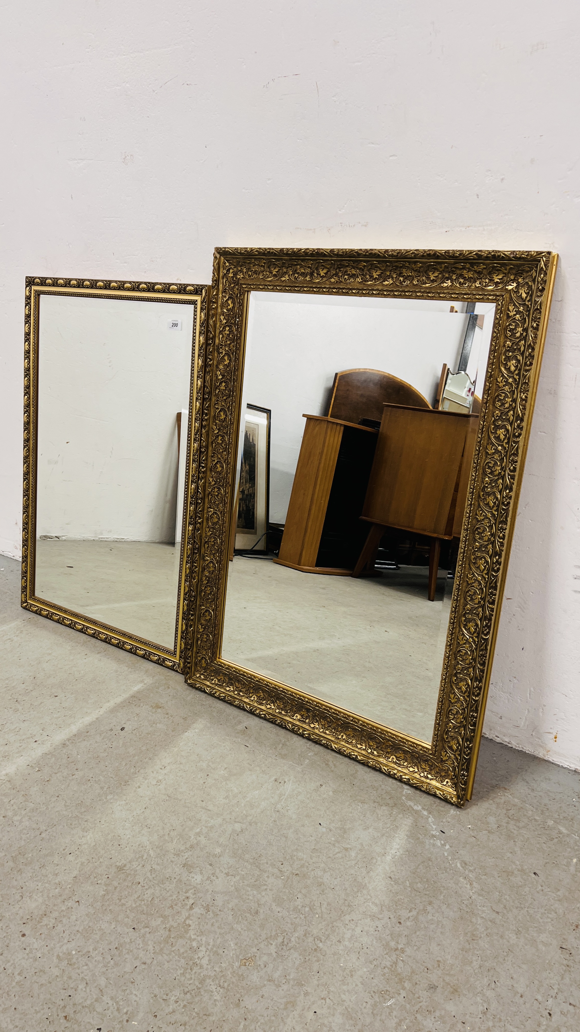 2 X GILT FRAMED WALL MIRRORS WITH BEVELLED GLASS PLATES 90 X 64CMM AND 83 X 58CM.