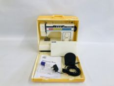 A TOYOTA EC1 SERIES SEWING MACHINE IN CASE WITH ACCESSORIES MODEL 2727.