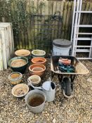 A GROUP OF ELEVEN VARIOUS GARDEN PLANTERS, BUILDERS WHEEL BARROW, GALVANISED DUSTBIN, WATERING CAN,