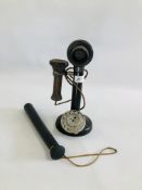 A VINTAGE DIAL CANDLESTICK TELEPHONE ALONG WITH A RUBBER TRUNCHEON.