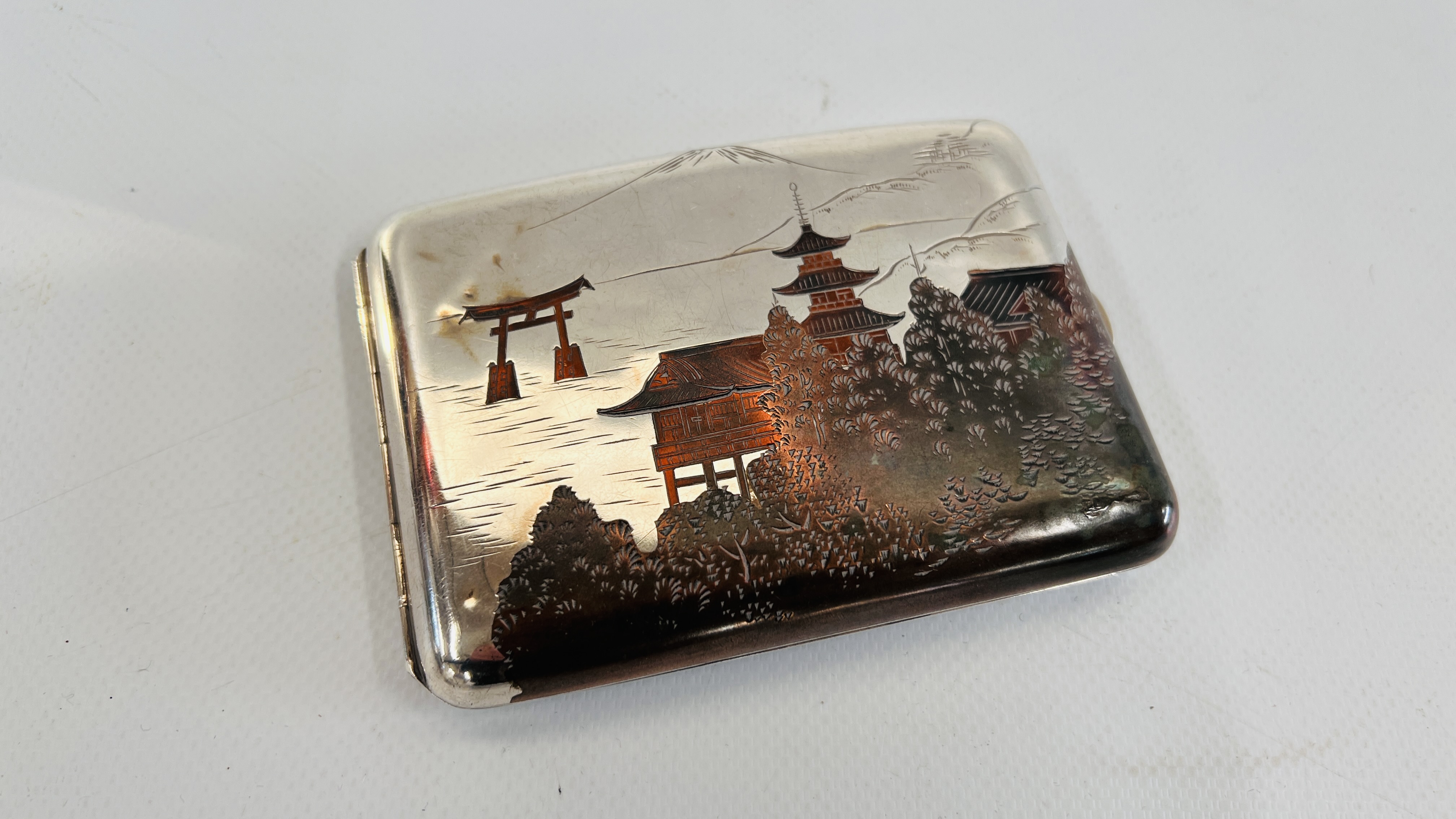 A JAPANESE STYLE SILVER AND MIXED METAL CIGARETTE CASE. L 11.5CM. X H 8CM.