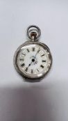 A LADIES SILVER CASED FOB WATCH, THE CASE HEAVILY DECORATED,