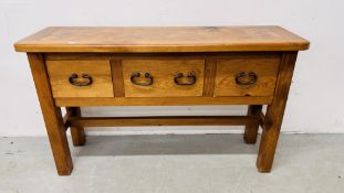 A SOLID BEECHWOOD AND PINE THREE DRAWER SIDE TABLE WITH RUSTIC IRON CRAFT HANDLES AND PARQUET