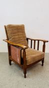 A 1930'S OAK EASY CHAIR WITH FOLDING BACK SECTION AND FOLDING SIDE TABLE.