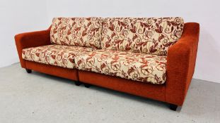 A LARGE MODERN RED UPHOLSTERED SOFA, WITH PATTERNED CUSHIONS - L 260CM. X H 80CM. X D 90CM.