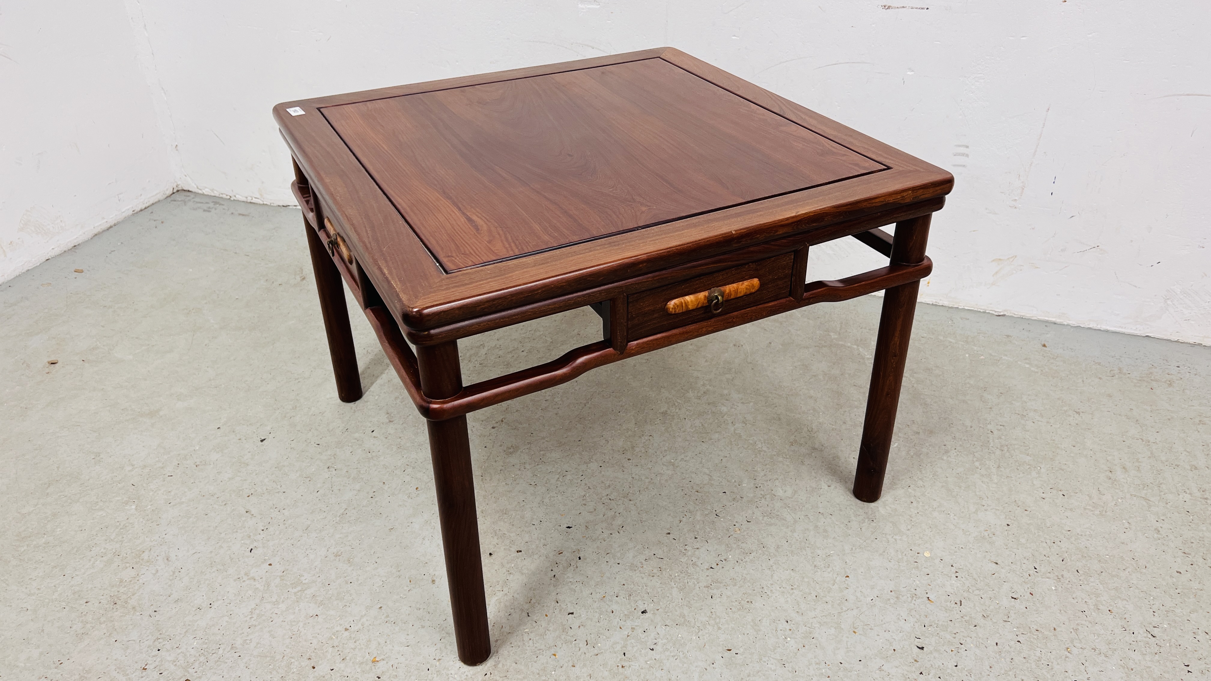 AN ORIENTAL SQUARE HARDWOOD FOUR DRAWER COFFEE / OCCASIONAL TABLE.