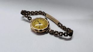 A LADIES 9CT GOLD WRIST WATCH ON A PLATED STRAP