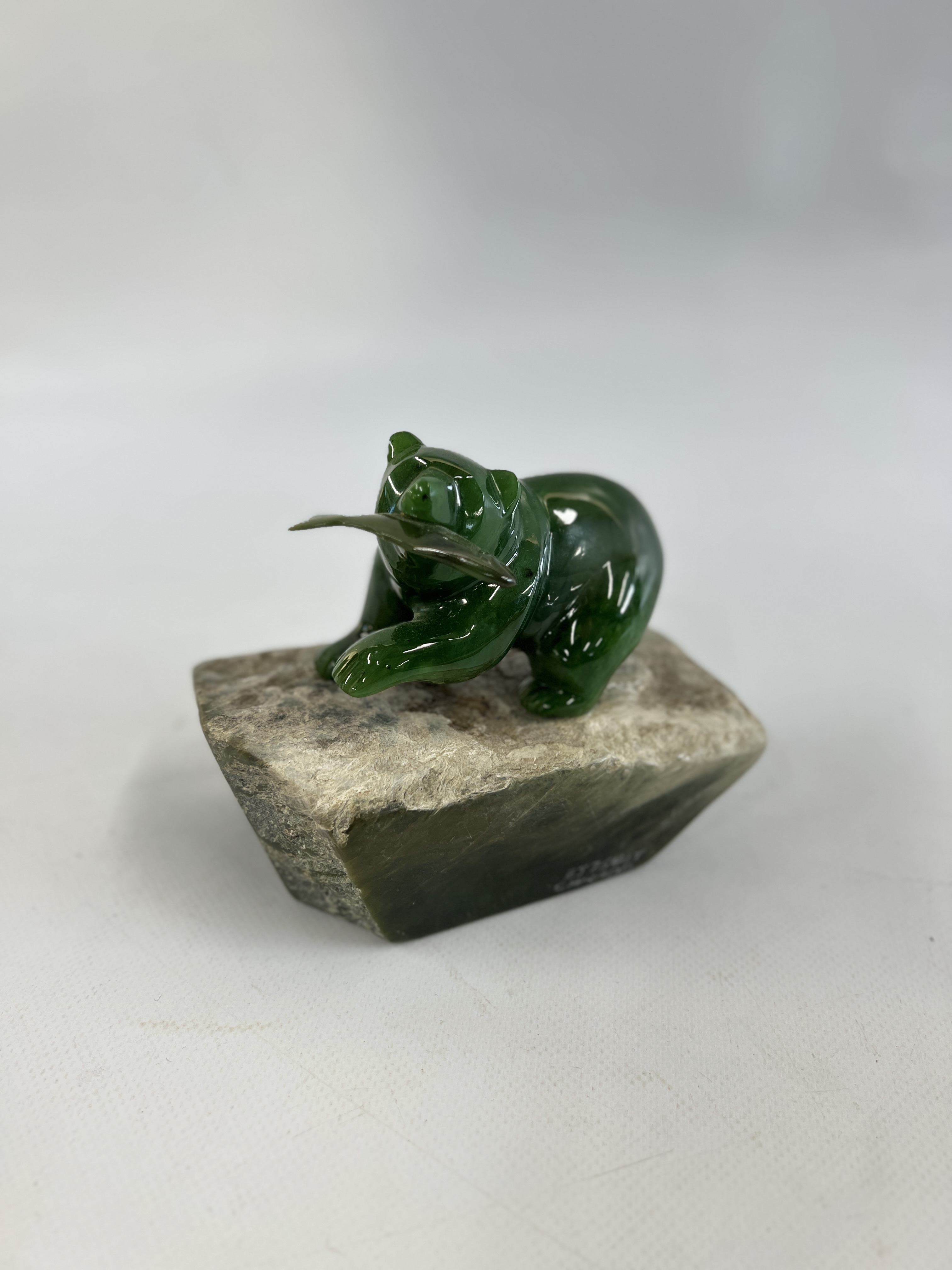 A B.C. JADE CARVING SIGNED BY CANADIAN ARTIST "TONY WU" FEATURES A BEAR