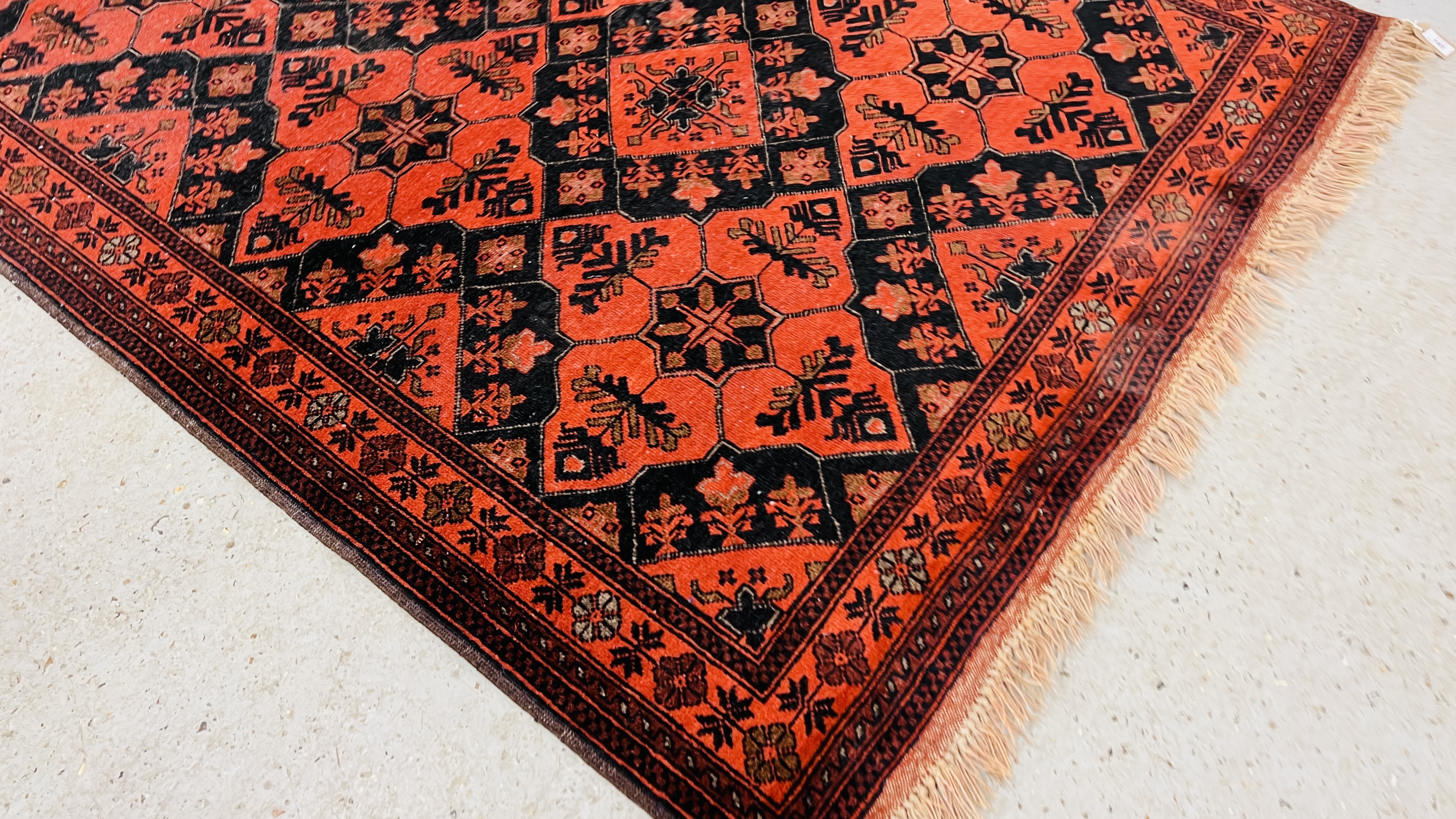 A RED PATTERNED EASTERN RUG. - Image 2 of 6