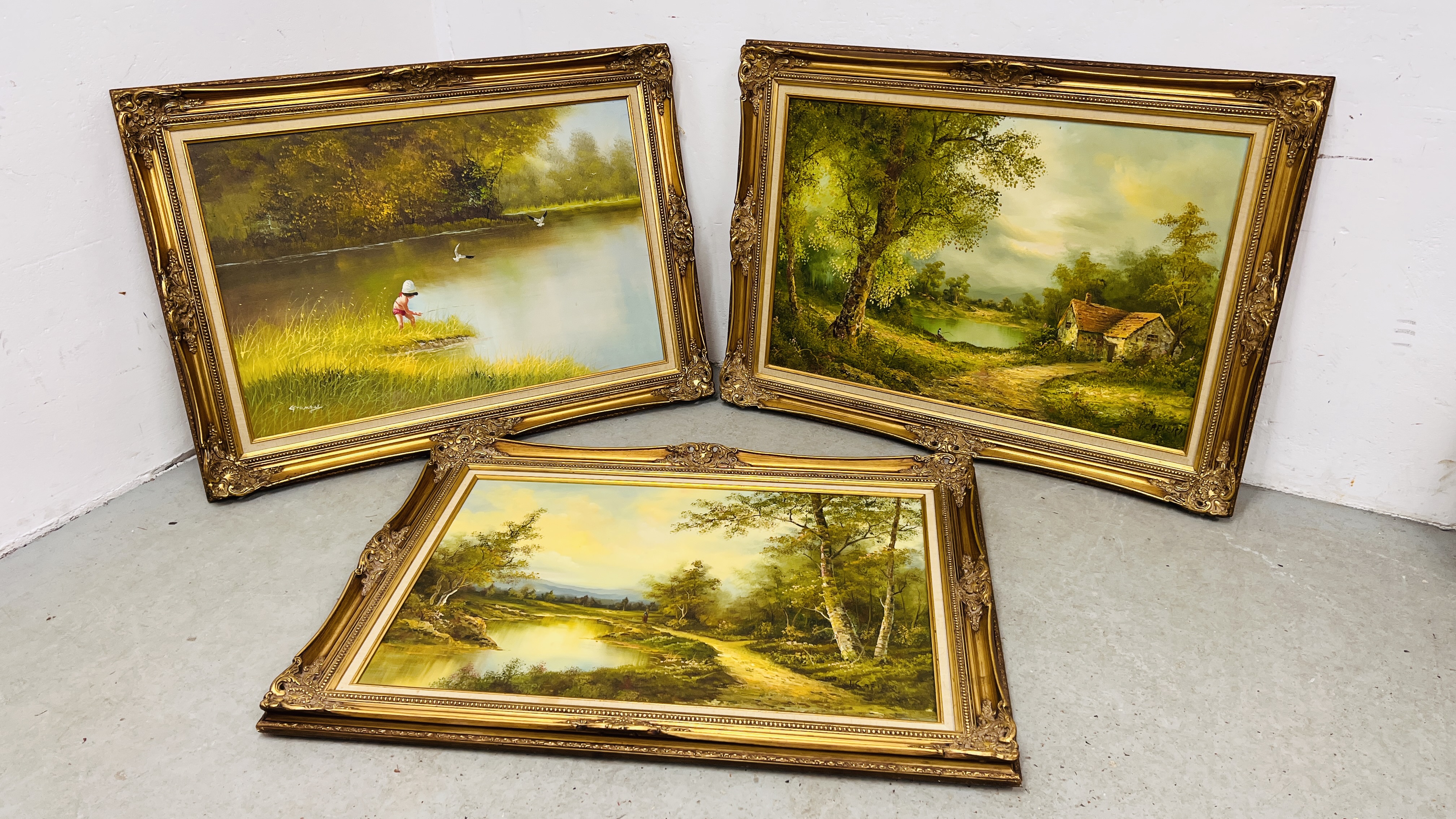 A GROUP OF 3 GILT FRAMED LANDSCAPE AND RIVER PICTURES, OIL ON CANVAS - W 112CM. X H 81.5CM.