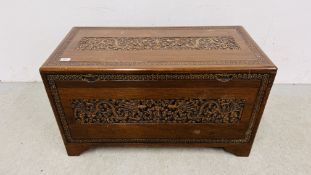 A CAMPER WOOD CHEST WITH HEAVILY DETAILED CARVING OF DRAGONS - W 92CM. X D 45CM. X H 52CM.