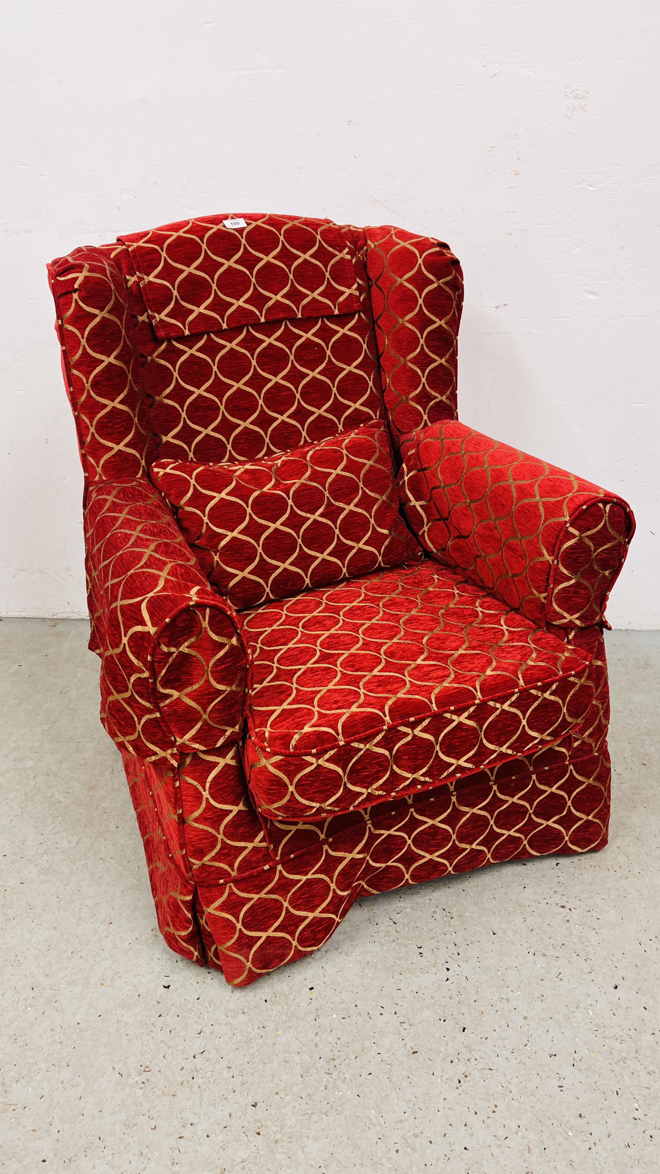 A MODERN WING BACK CHAIR UPHOLSTERED IN RED AND GOLD