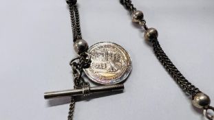 A WHITE METAL WATCH CHAIN SUPPORTING A VICTORIAN SILVER COIN.