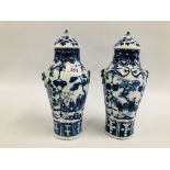 A PAIR OF ORIENTAL BLUE AND WHITE LIDDED URNS, DECORATED WITH FIGURES AND BLOSSOM,