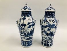 A PAIR OF ORIENTAL BLUE AND WHITE LIDDED URNS, DECORATED WITH FIGURES AND BLOSSOM,