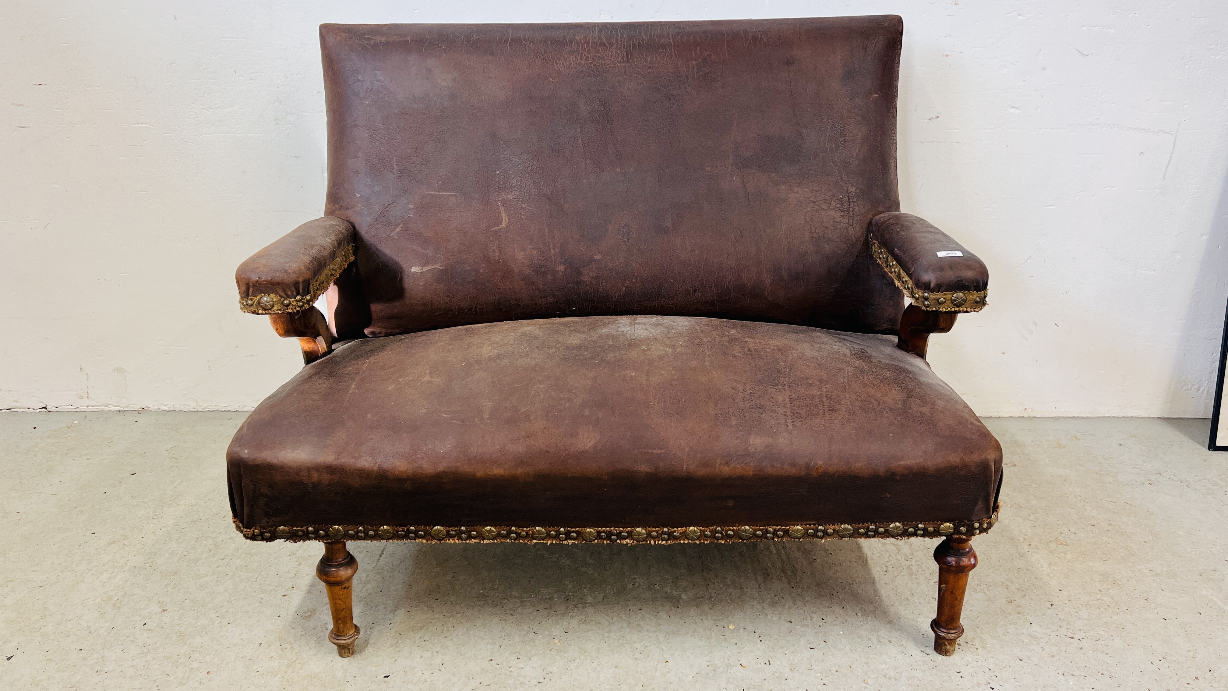 A VINTAGE LEATHER UPHOLSTERED BENCH - W 125CM.