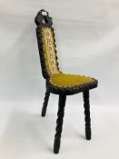 AN ARTS AND CRAFTS STYLE SPINNING CHAIR ON TURNED TRIPOD LEGS UPHOLSTERED WITH A NEEDLEWORK PANEL.
