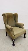 AN ANTIQUE WING BACK CHAIR WITH BALL AND CLAW DETAIL TO FORE LEGS, THE FRAME STAMPED 5686,