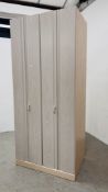 A MODERN LIMED OAK FINISH WARDROBE WITH CANTILEVER DOOR ACTION W 90CM. D 58CM. H 204CM.