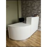 A WHITE FINISH RECEPTION DESK WITH CORNER ADD ON SECTION AND OFFICE CHAIR.