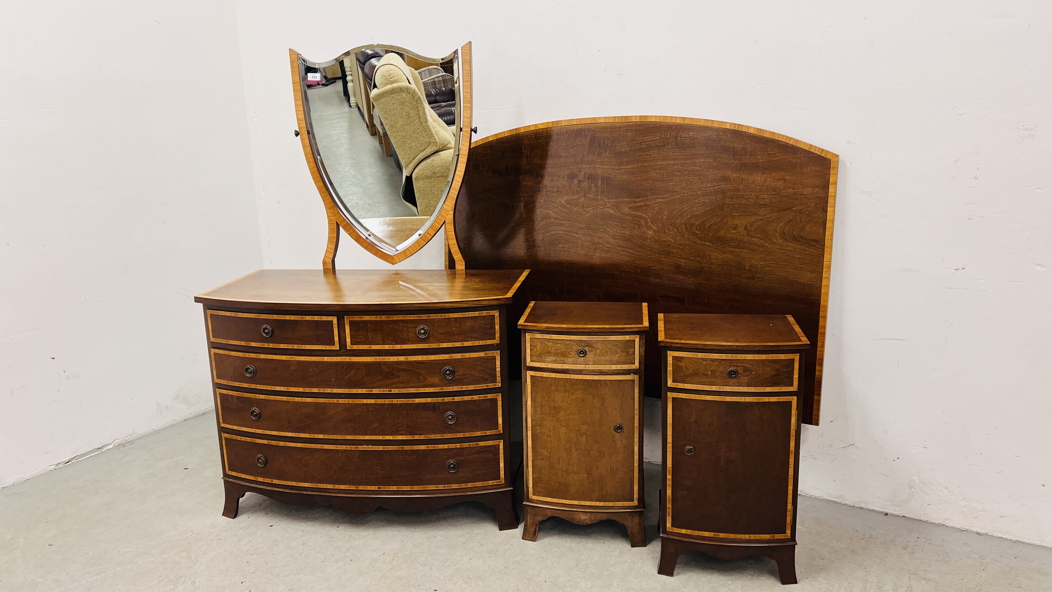 A GOOD QUALITY MAHOGANY TWO OVER THREE DRAWER BOW FRONTED DRESSING CHEST WITH SHIELD SHAPE MIRROR